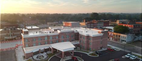 Un hotel Courtyard Marriott con estacionamiento y edificios circundantes.