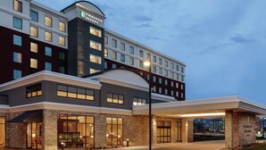 A modern hotel with a prominent entrance, large windows, and a well-lit facade. - Embassy Suites by Hilton South Jordan Salt Lake City (South Jordan)