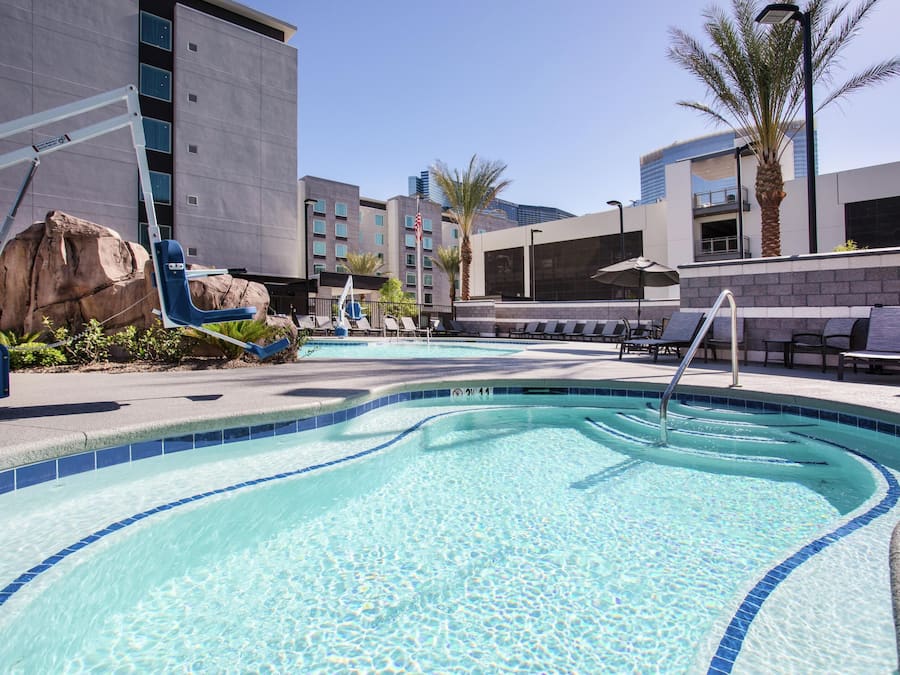 Outdoor pool, open 7 AM to 10 PM, pool umbrellas, sun loungers