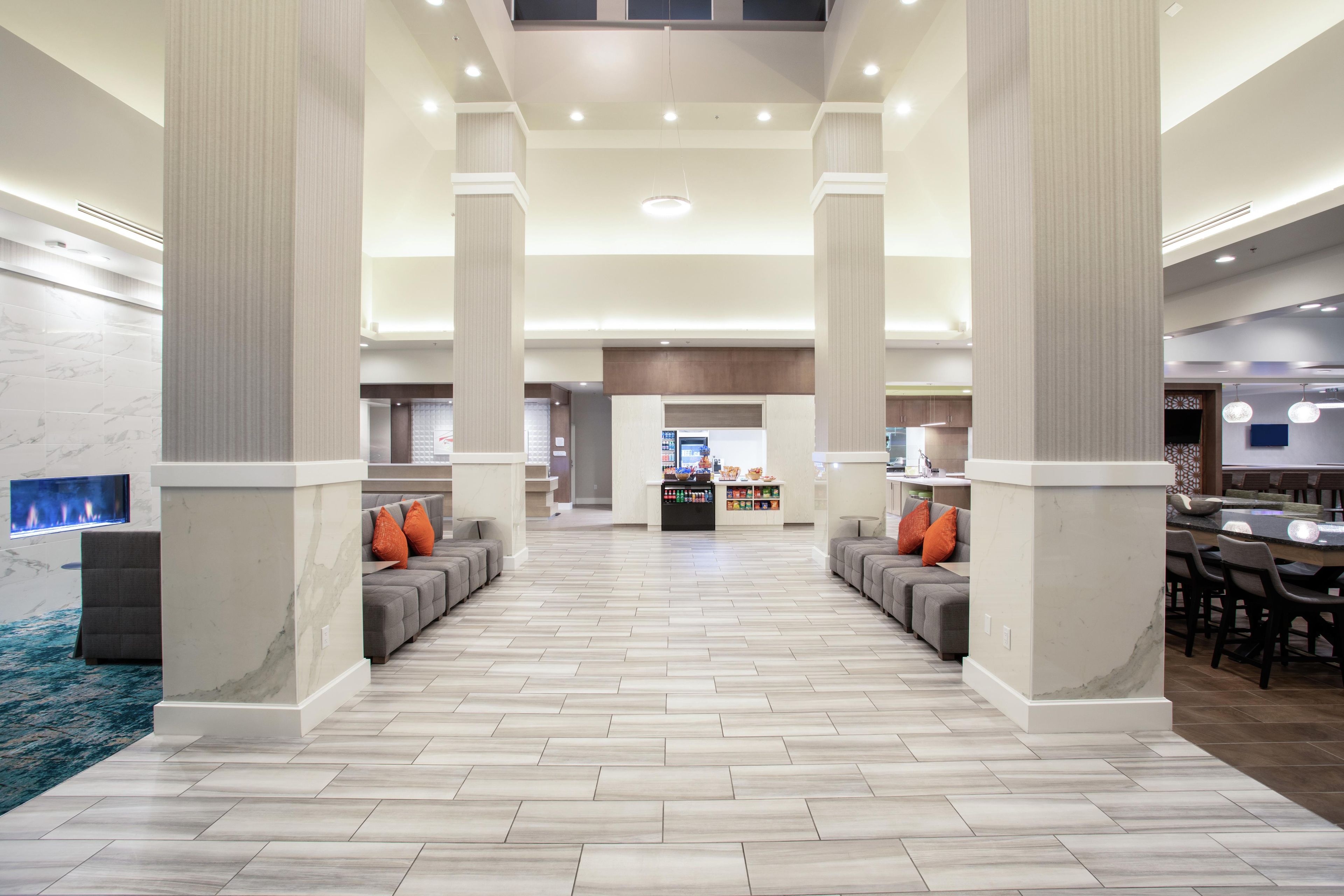 A spacious lobby with a central seating area, high ceilings, and a modern design.