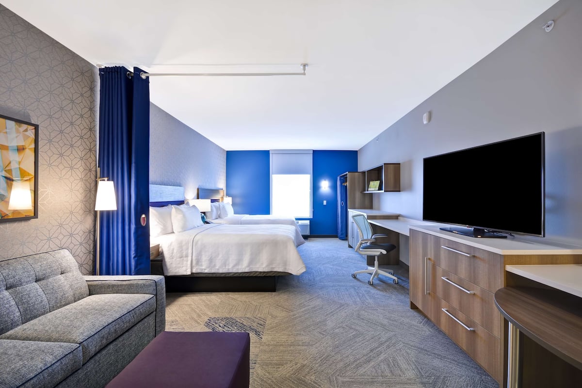 hypo-allergenic bedding, desk, laptop workspace, blackout curtains