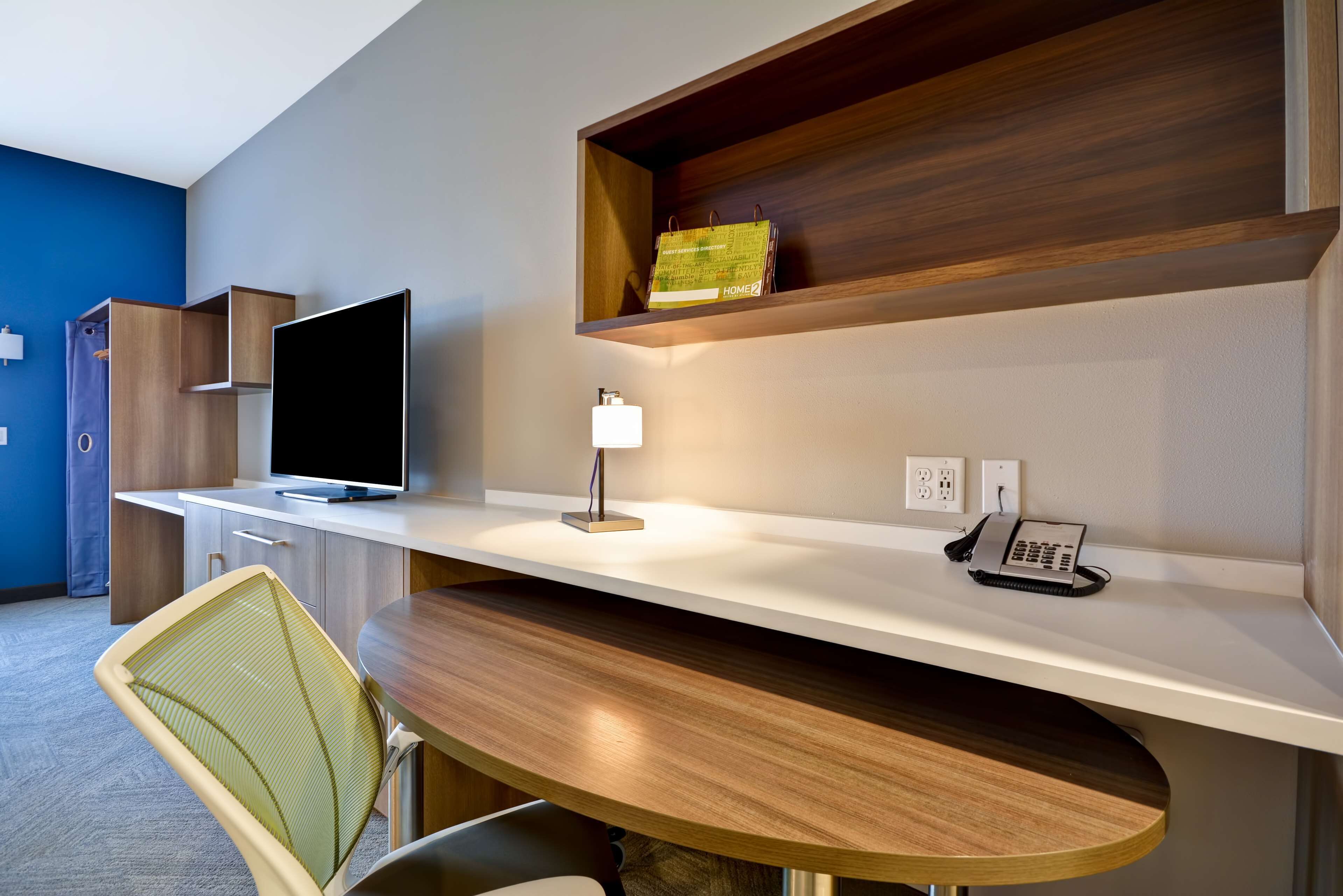 hypo-allergenic bedding, desk, laptop workspace, blackout curtains