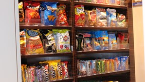 A snack display in a store with various packaged snacks and beverages. - Comfort Inn St. Louis Airport (Bridgeton)