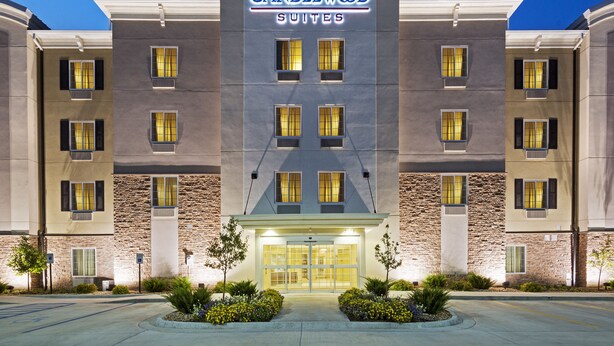 A hotel with a modern facade, multiple windows, and a well-lit entrance. - Candlewood Suites San Antonio Lackland AFB Area by IHG (San Antonio)