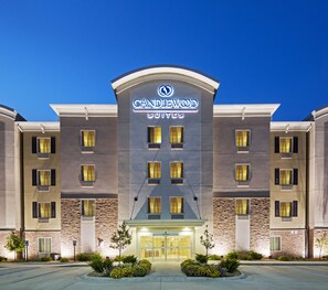 A hotel with a modern facade, multiple windows, and a well-lit entrance. - Candlewood Suites San Antonio Lackland AFB Area by IHG (San Antonio)