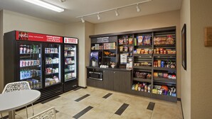 A vending area with Coca-Cola and Candlewood Cupboard machines, a microwave, and a variety of snacks and beverages. - Candlewood Suites San Antonio Lackland AFB Area by IHG (San Antonio)