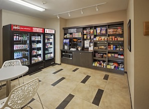 A vending area with Coca-Cola and Candlewood Cupboard machines, a microwave, and a variety of snacks and beverages. - Candlewood Suites San Antonio Lackland AFB Area by IHG (San Antonio)