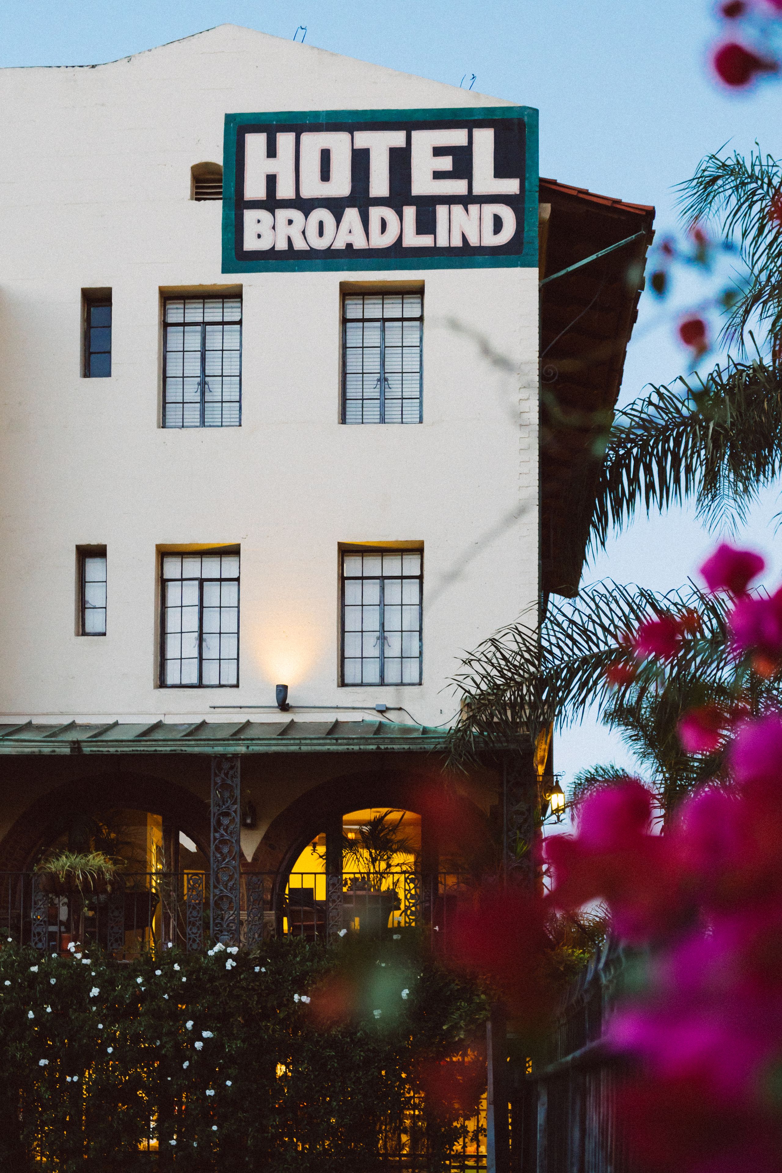 A hotel named "HOTEL BROADLIND" with a white facade, multiple windows, and a sign above the entrance.
