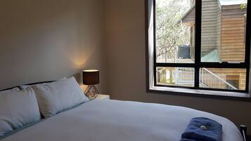 Apartment, 2 Bedrooms (1 Queen + 1 Tri-Bunk) | 2 bedrooms, iron/ironing board, cots/infant beds, bed sheets