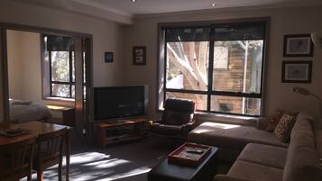 Apartment, 2 Bedrooms (1 Queen + 1 Tri-Bunk) | Living area | Flat-screen TV
