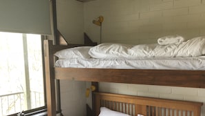 A bunk bed with white bedding and a wooden headboard. - Snowflake 13 (Mount Buller)
