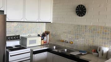 1-Bedroom Apartment (1 Queen Bed, 1 Tri-Bunk, 1 Murphy Bed) | Private kitchen | Full-sized fridge, microwave, oven, stovetop