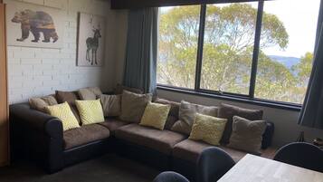 1-Bedroom Apartment (1 Queen Bed, 1 Tri-Bunk, 1 Murphy Bed) | Living area | Flat-screen TV, DVD player