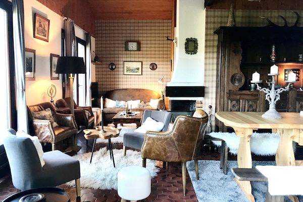 Élégant salon convivial au coin du feu face à la vue sur la montagne