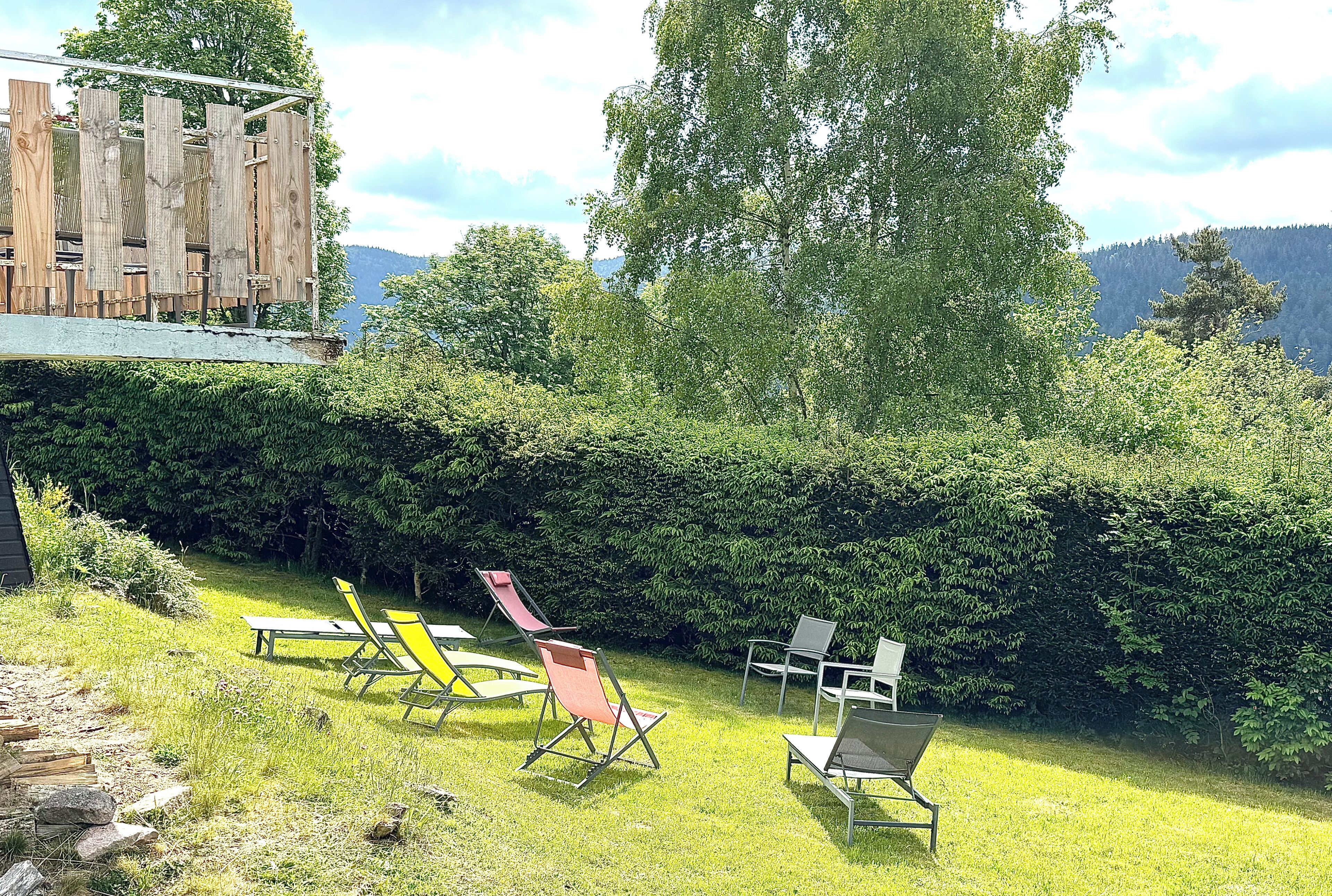 A garden with outdoor seating and a wooden structure.