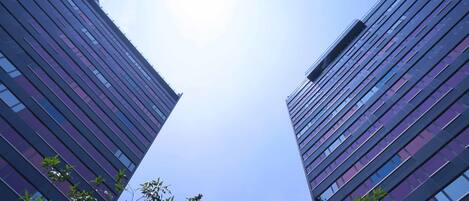 Two high-rise buildings with a clear sky.