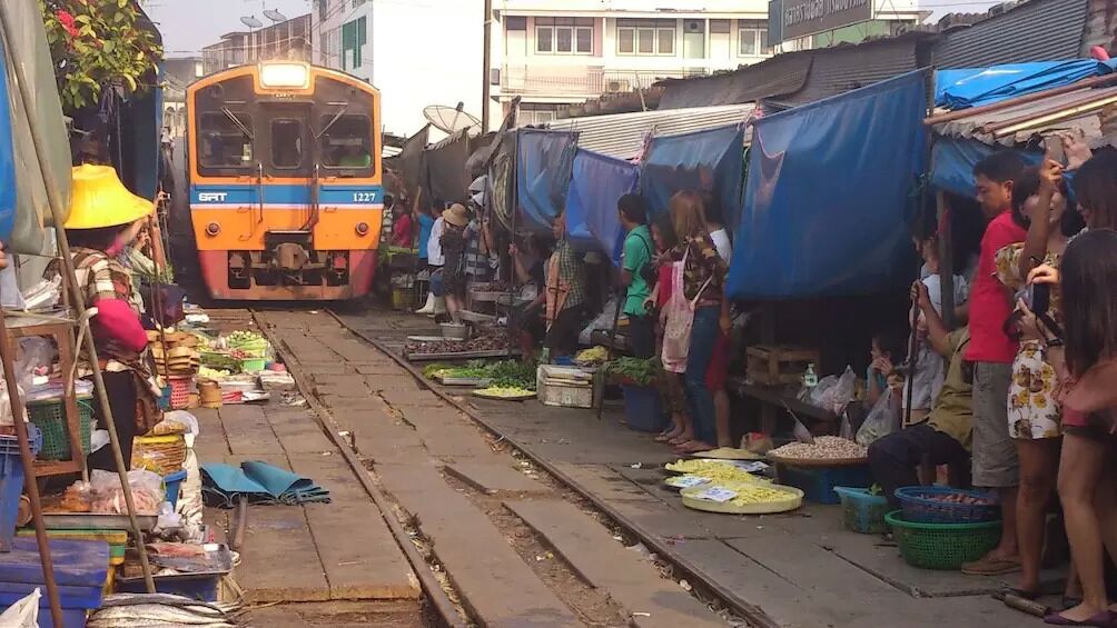 A market scene with a train in the background.