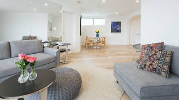 Apartment, 1 Queen Bed with Sofa bed, Beach View, Beachfront | Living area | Flat-screen TV