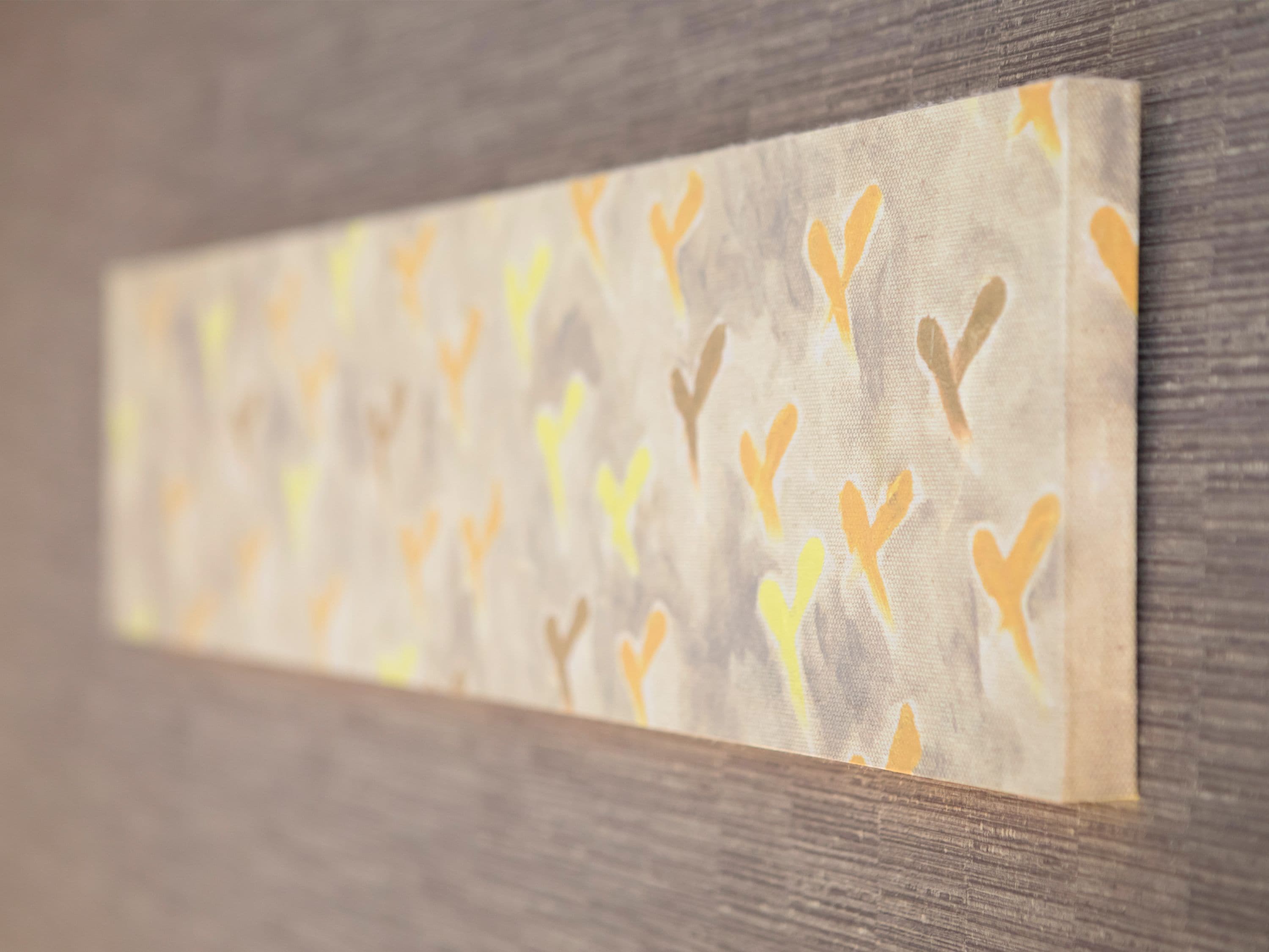 A close-up of a textured wall with a pattern of abstract shapes.