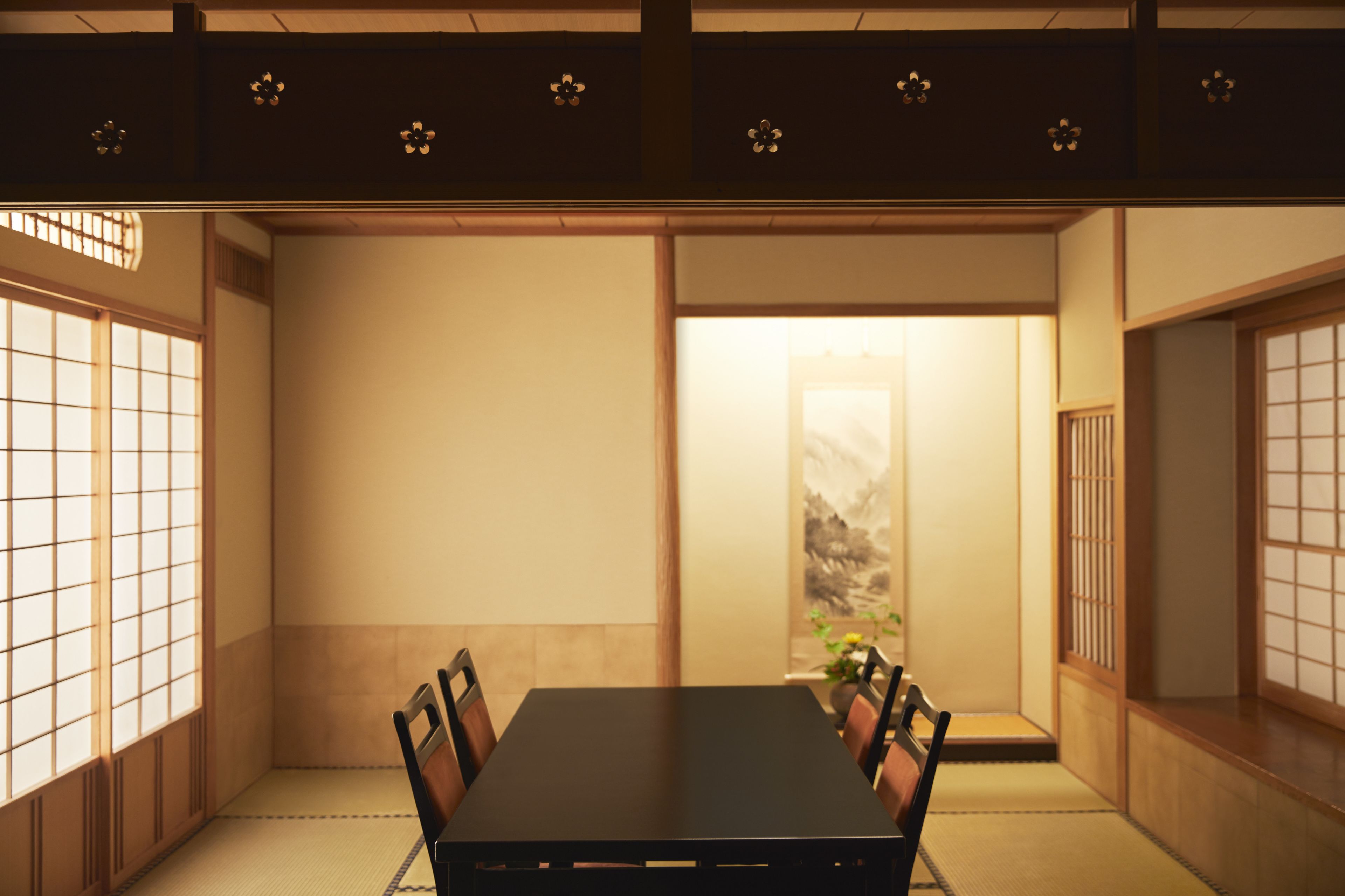 A traditional Japanese room with tatami flooring, a low table, and shoji screens.
