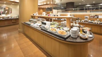 A buffet area with various food items and dishes.
