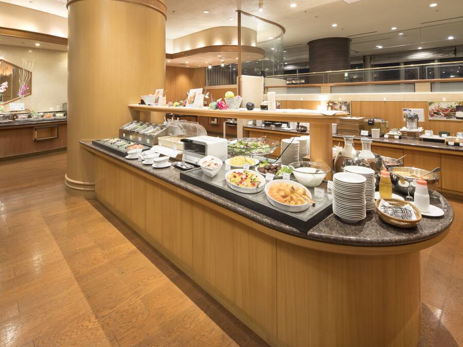 A buffet area with various food items and dishes.