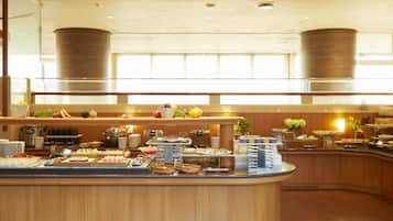 A buffet setup with various food items and beverages.