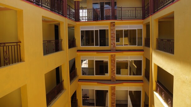 A multi-story building with balconies and large windows. - Oasis Top Hotel (Kampala)