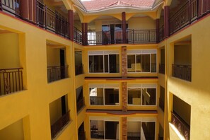 A multi-story building with balconies and large windows. - Oasis Top Hotel (Kampala)