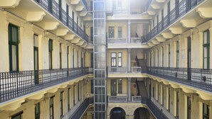 A multi-story building with balconies, staircases, and arched doorways. - Dominik Apartment (Budapest)