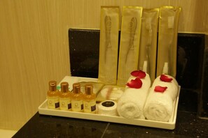 A hotel bathroom with toiletries and towels arranged on a tray. - Pacific Hotel (Yangon)