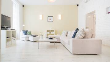 Deluxe Apartment | Living room | 1-inch flat-screen TV with digital channels, TV, DVD player