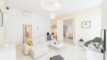 Deluxe Apartment | Living room | 1-inch flat-screen TV with digital channels, TV, DVD player