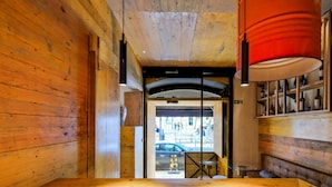 A wooden interior with a view to the street, a bench, and a table. - Chiado Arty flats (Lisbon)