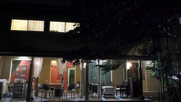 A two-story building with a covered outdoor seating area. - Nonnaisuan resort (Bangkok)