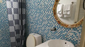 A bathroom with a toilet, sink, and shower curtain. - Nonnaisuan resort (Bangkok)