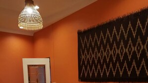 A room with two beds, a patterned tapestry, and a hanging light fixture. - Nonnaisuan resort (Bangkok)