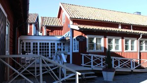 A wooden building with a white porch and a sign that reads "Hotel & Restaurant." - Sätra Brunn Hälsobrunn (Sala)