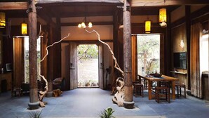 A traditional wooden interior with a central archway, wooden pillars, and hanging lanterns. - Huangshan Huizhou Creek Villa (Huangshan)
