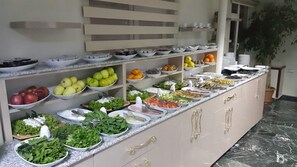 A buffet with various food items and utensils. - Yeni Hotel (Malatya)
