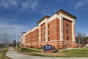 A large brick building with a sign reading "Hampton Inn & Suites by Hilton." - Hampton Inn & Suites Knightdale Raleigh (Raleigh)