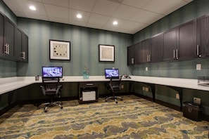 A conference room with two desks, chairs, and two monitors. - Hampton Inn & Suites Knightdale Raleigh (Raleigh)