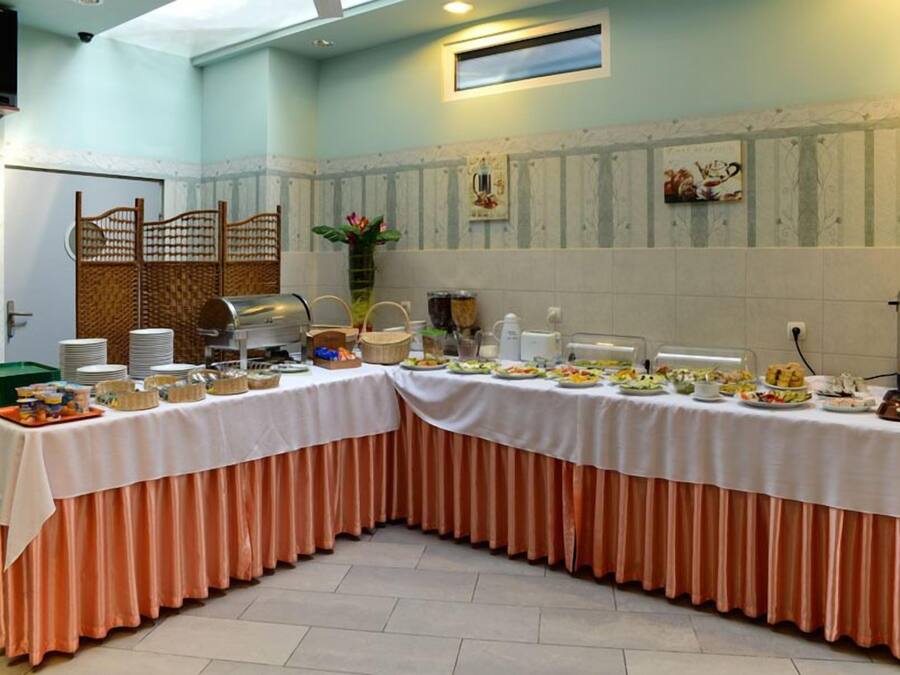 A buffet setup with a variety of food items and a decorative vase.