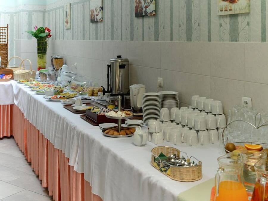 A buffet setup with various food items, a coffee station, and a beverage station.