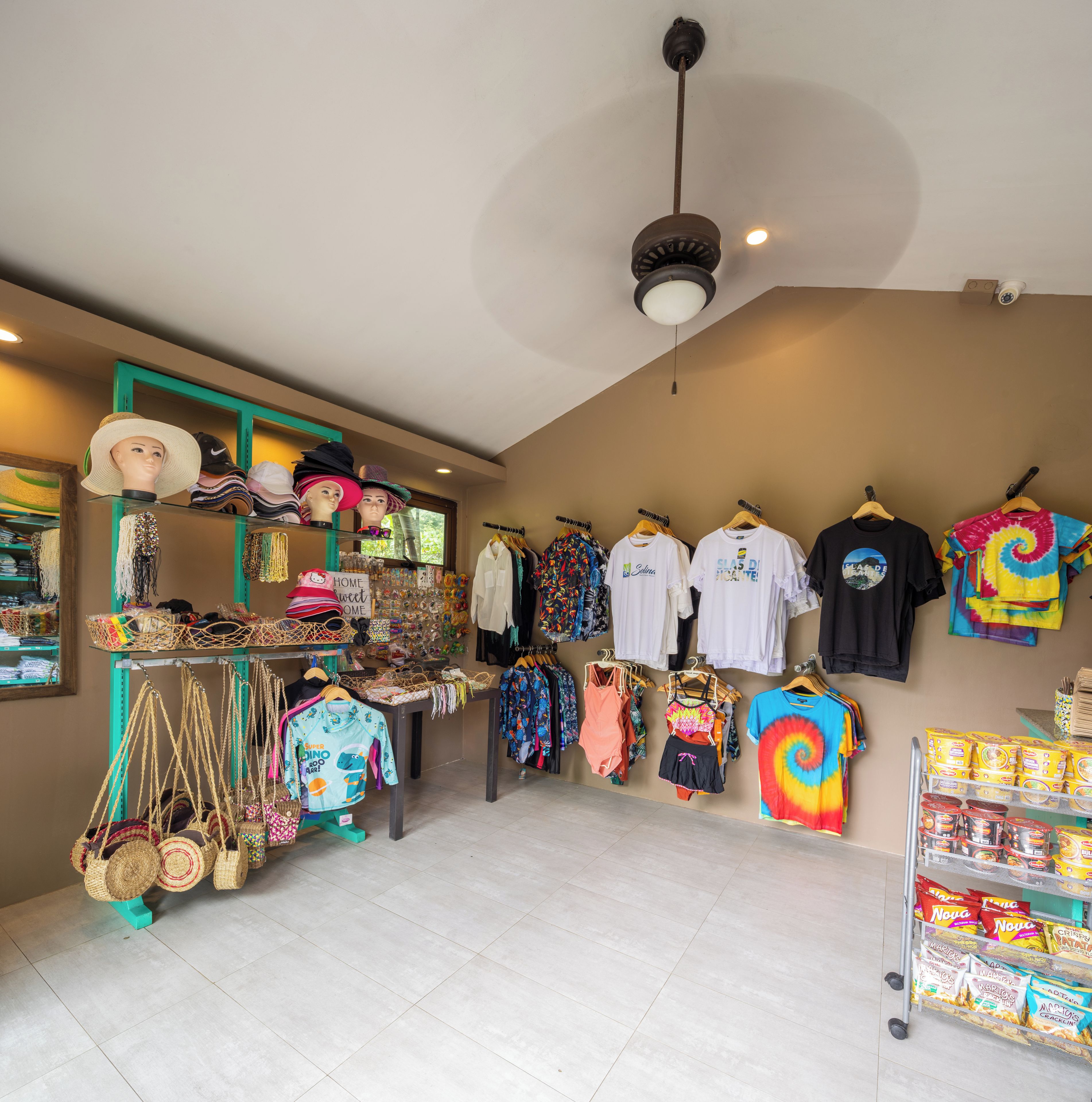 A retail space with clothing racks, a mannequin, and shelves with various items.