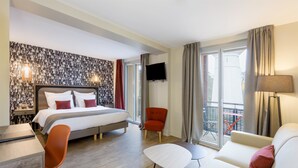 A hotel room with a bed, a desk, a chair, a sofa, and a TV. - Best Western La Porte des Châteaux (Meung-sur-Loire)