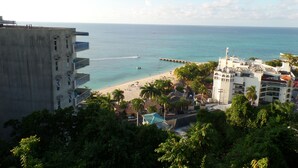 A coastal view with a beach, a pier, and buildings. - Hipstrip Beach Studio (Montego Bay)