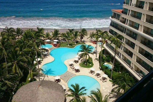 Una piscina al aire libre, sillones reclinables de piscina