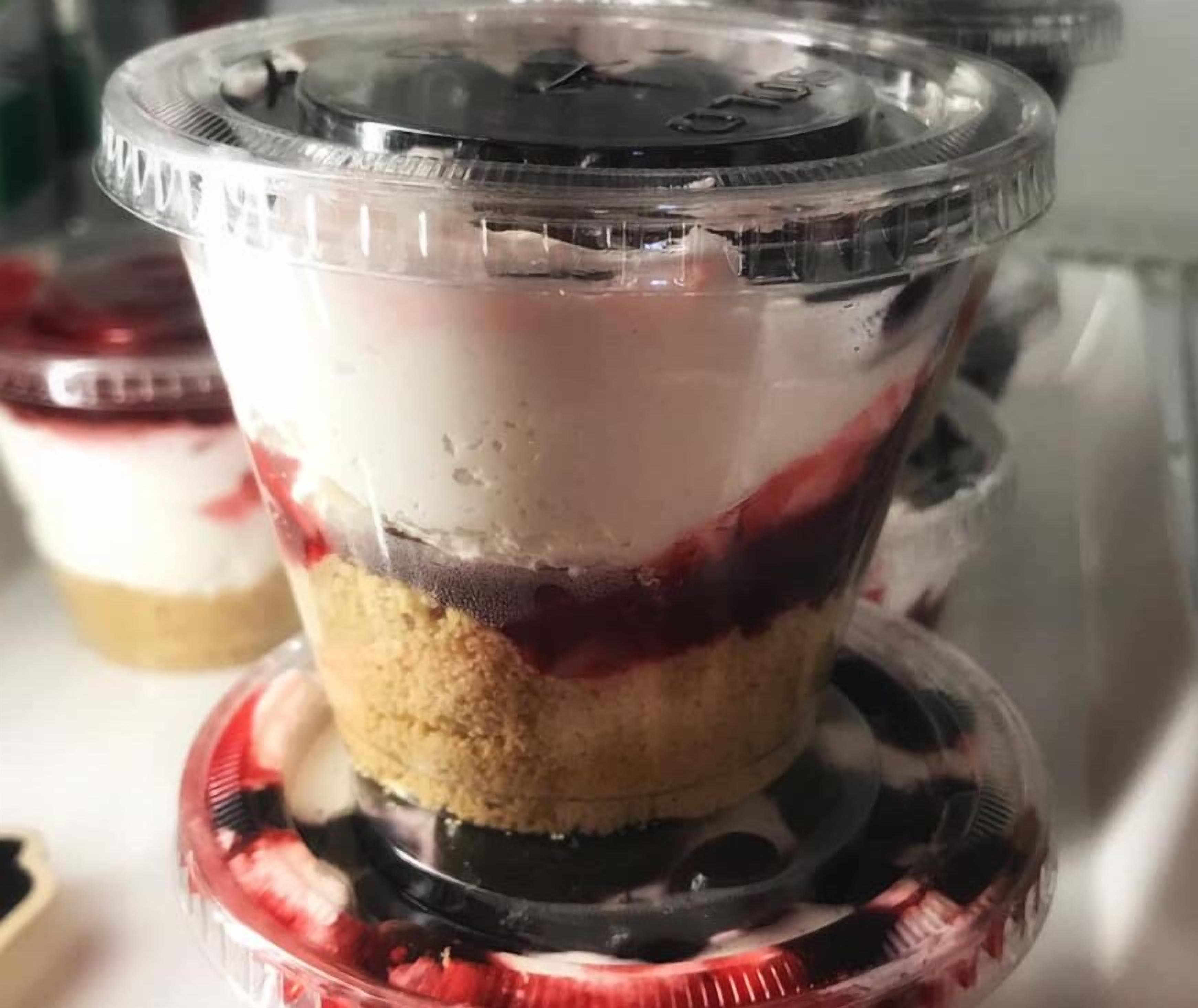 A dessert in a clear plastic container with a lid.
