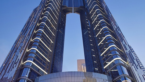 Un edificio de gran altura con una fachada curva distintiva y una entrada central.